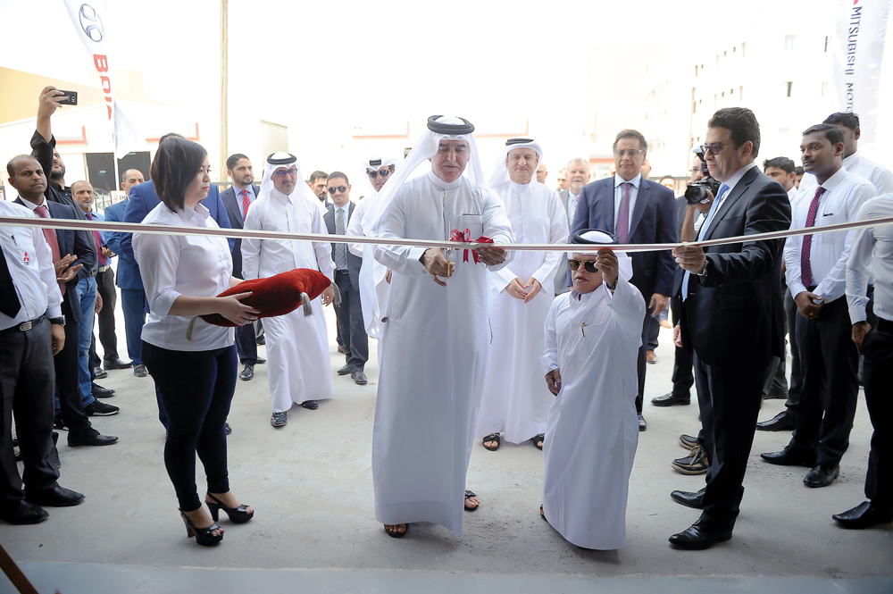 Sheikh Nawaf Nasser bin Khaled Al Thani, Chairman and CEO of NBK Holding, cutting the ribbon to open QAC Bodyshop at Street 18, Industrial Area in Doha, on Monday.