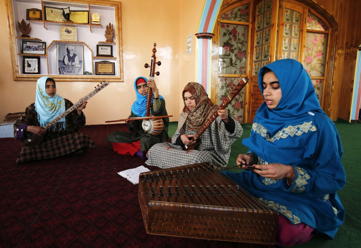 In this photograph taken on February 25, 2017, Kashmiri Muslim girls play instruments and sing Sufi music under the tutelage of music teacher, Muhammad Yaqoob Sheikh, on the outskirts of Srinagar. AFP 