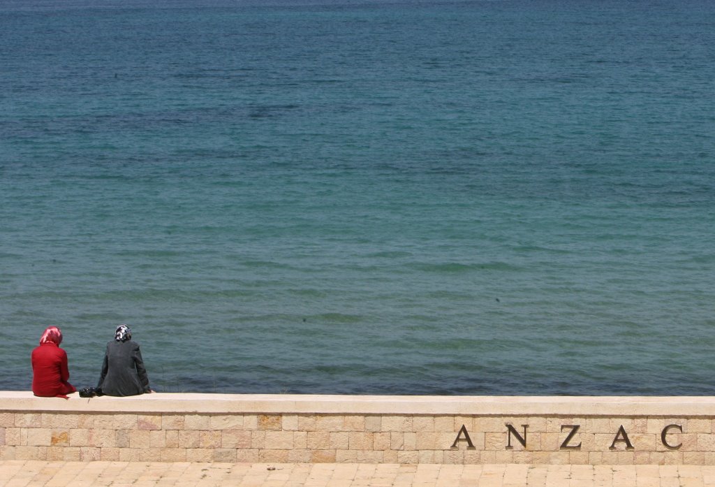 File photo: Two Turkish tourists sit at Anzac Cove where the first battle was fought in Gallipoli. Reuters/Osman Orsal/File Photo