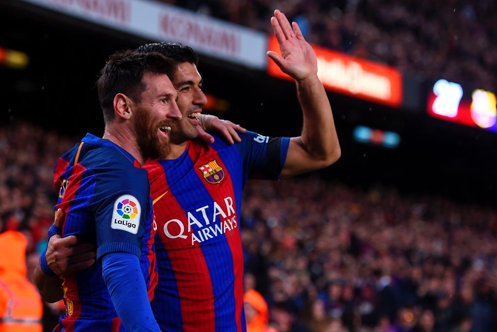 Barcelona's Argentinian forward Lionel Messi (L) is congratulated by Barcelona's Uruguayan forward Luis Suarez after scoring during the Spanish league football match FC Barcelona vs Sevilla FC at the Camp Nou stadium in Barcelona on April 5, 2017. / AFP /