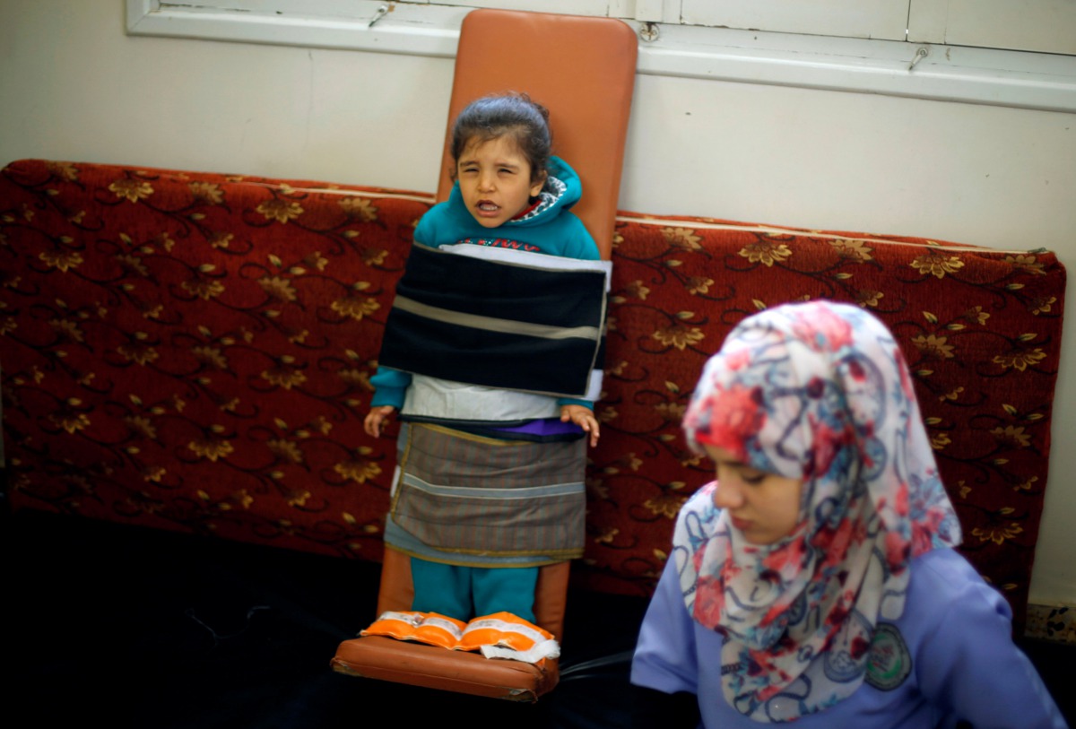 Palestinian girl Rasha al-Bayed, 5, who suffers from cerebral palsy, attends a physiotherapy session at Mabaret Falasteen charity in Gaza City, March 20, 2017. REUTERS/Mohammed Salem