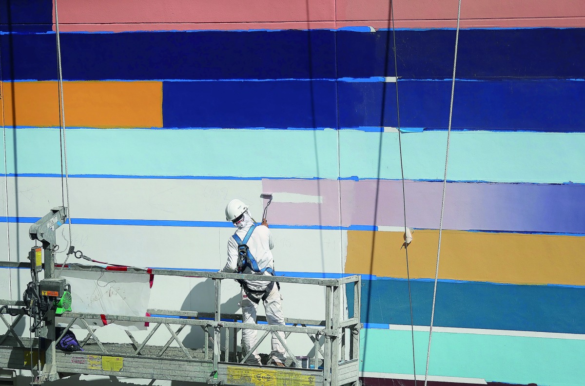 Painters  at work on a newly constructed building in Miami, Florida.