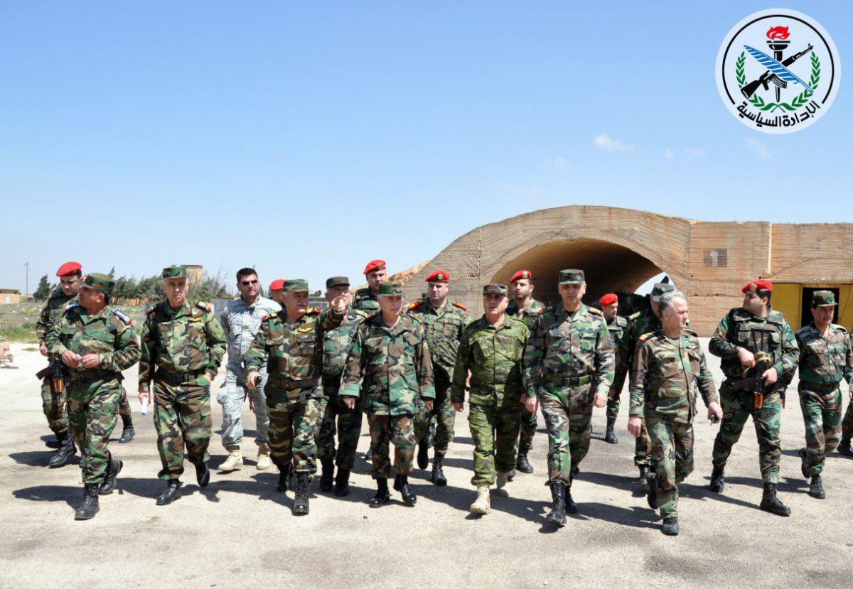 A handout picture released by the official Syrian Arab News Agency (SANA) on April 7, 2017, reportedly shows Syrian Armed Forces' chief of staff, Ali Abdullah Ayyoub (C), visiting Shayrat (