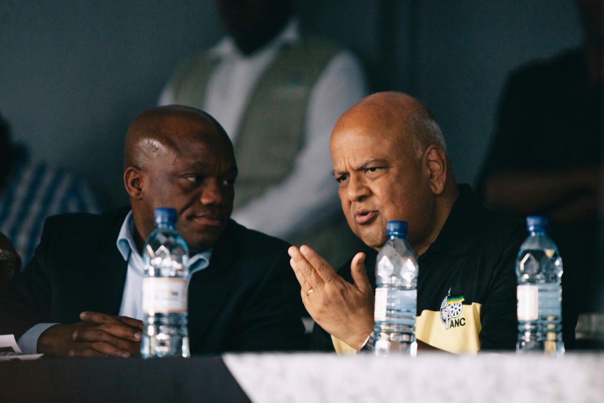 African National Congress Kwa Zulu Natal chair Sihle Zikalala (L) andSouth Africa's sacked finance minister Pravin Gordhan (R) talks during in a memorial for anti apartheid stalwart Ahmed Kathrada on April 9, 2017 in Durban, South Africa. Pravin Gordhan w