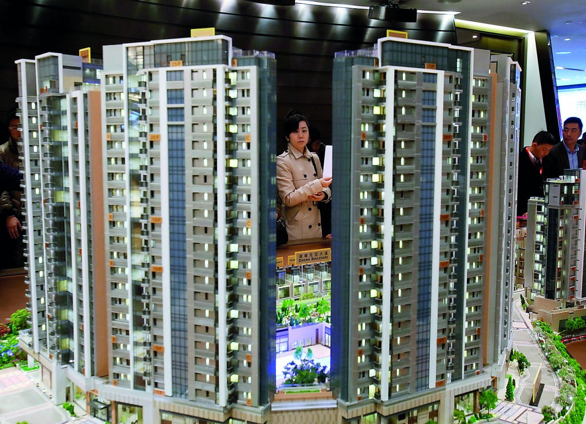 A potential buyer looks at a model of Riva, one of the latest developments by Sun Hung Kai Properties, in Hong Kong.
