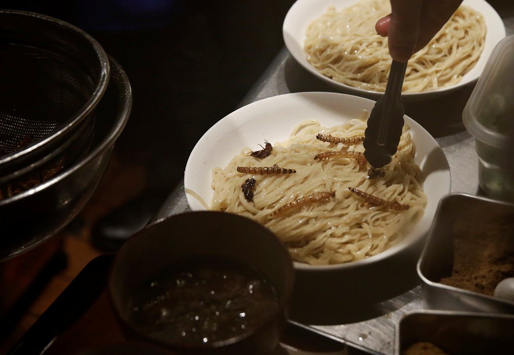 A chef places worms and crickets on a noodle as he serves 'insect tsukemen' noodle at 'Ramen Nagi' restaurant in Tokyo, Japan April 9, 2017. Picture taken on April 9, 2017. REUTERS/Kim Kyung-Hoon
