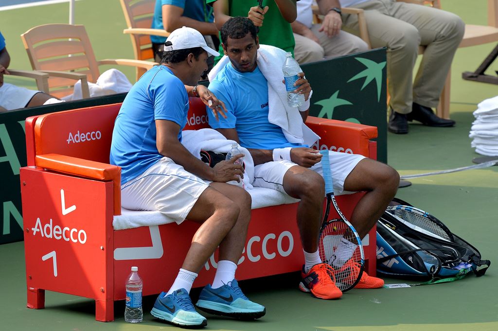 Indian player Ramkumar Ramanathan (R) speaks with his team's non-playing captain Mahesh Bhupathi during a break in his singles match against Uzbekistan's Temur Ismailov at the Davis Cup Asia Oceania group one tie match held between India and Uzbekistan at