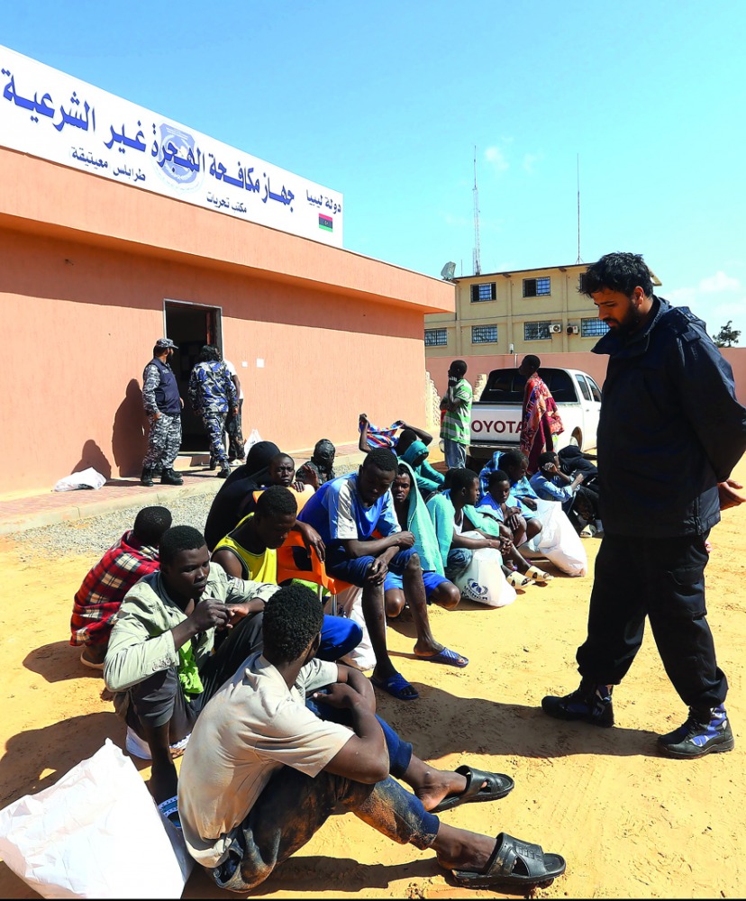 African migrants, whose boat sank off the Libyan coast, gather upon after their rescue at the Tripoli branch of the Anti-Illegal Immigration Authority, in the Libyan capital, yesterday.