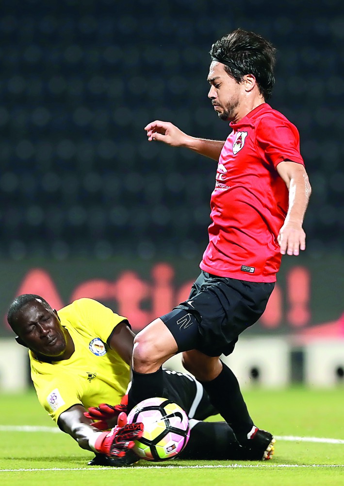 Al Rayyan skipper Rodrigo Tabata (tries to kick past the Al Khor goalkeeper during their QSL match.