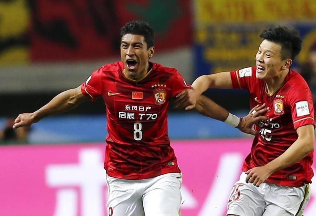 File photo: Paulinho (L) of China's Guangzhou Evergrande celebrates with teammate Zou Zheng after scoring against Mexico's Club America during their Club World Cup quarter-final soccer match in Osaka, western Japan, December 13, 2015. Reuters/Thomas Peter