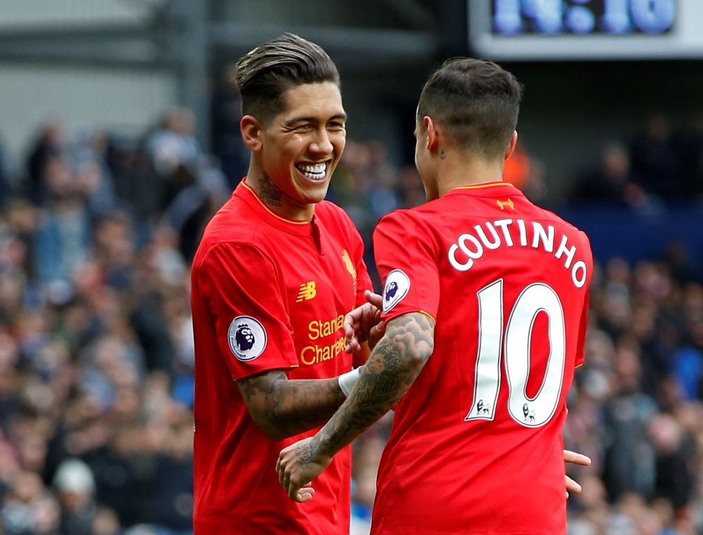 Liverpool's Roberto Firmino celebrates scoring their first goal with Philippe Coutinho. Reuters / Andrew Yates 
