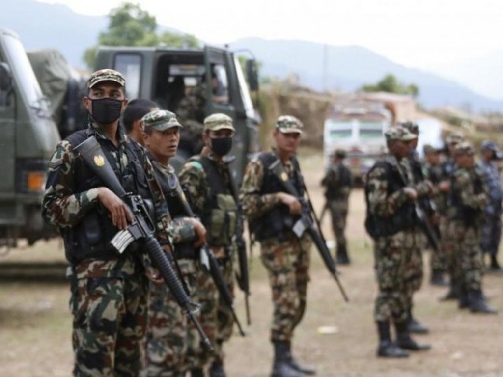 Soldiers guard supply trucks after local people forced an army truck carrying relief supplies off the road, saying they have not received any government food aid five days after Saturday's earthquake, near Chautara, Nepal. PHOTO: REUTERS.