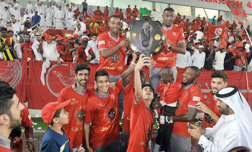 Lekhwiya players celebrate with the Falcon Shield after their last QSL match against Al Shahania on Saturday at Lekhwiya Stadium. 