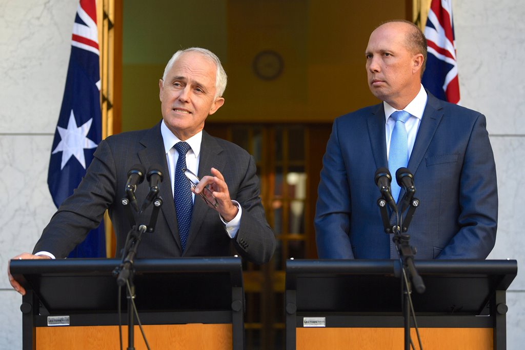 Australia's Prime Minister Malcolm Turnbull speaks as Immigration Minister Peter Dutton listens on during a media conference at Parliament House in Canberra, Australia, April 18, 2017. AAP/Lukas Coch/via Reuters