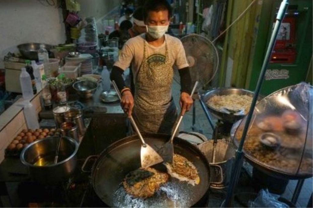 A man prepares food at a street stall in the Phrakanong district of Bangkok. (Photo: AFP/LILLIAN SUWANRUMPHA).