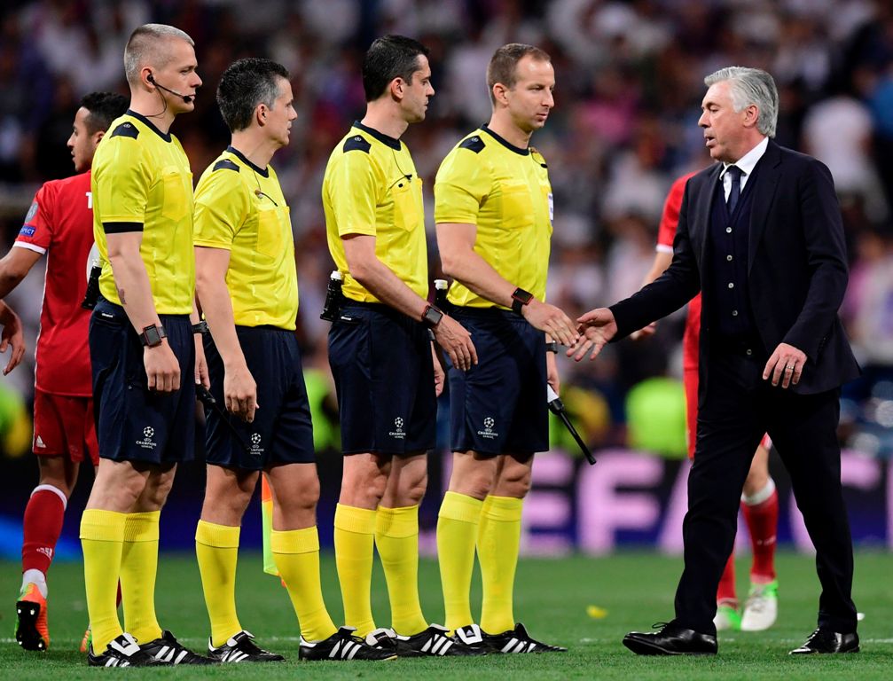 Bayern Munich's Italian head coach Carlo Ancelotti shakes hands with referees at the end of the UEFA Champions League quarter-final second leg football match Real Madrid vs FC Bayern Munich at the Santiago Bernabeu stadium in Madrid in Madrid on April 18,