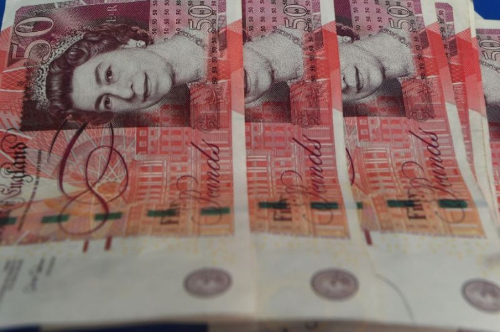 The pound has soared more than two percent since British Prime Minister Theresa May called a snap general election for June 8 (AFP Photo/MOHD RASFAN).