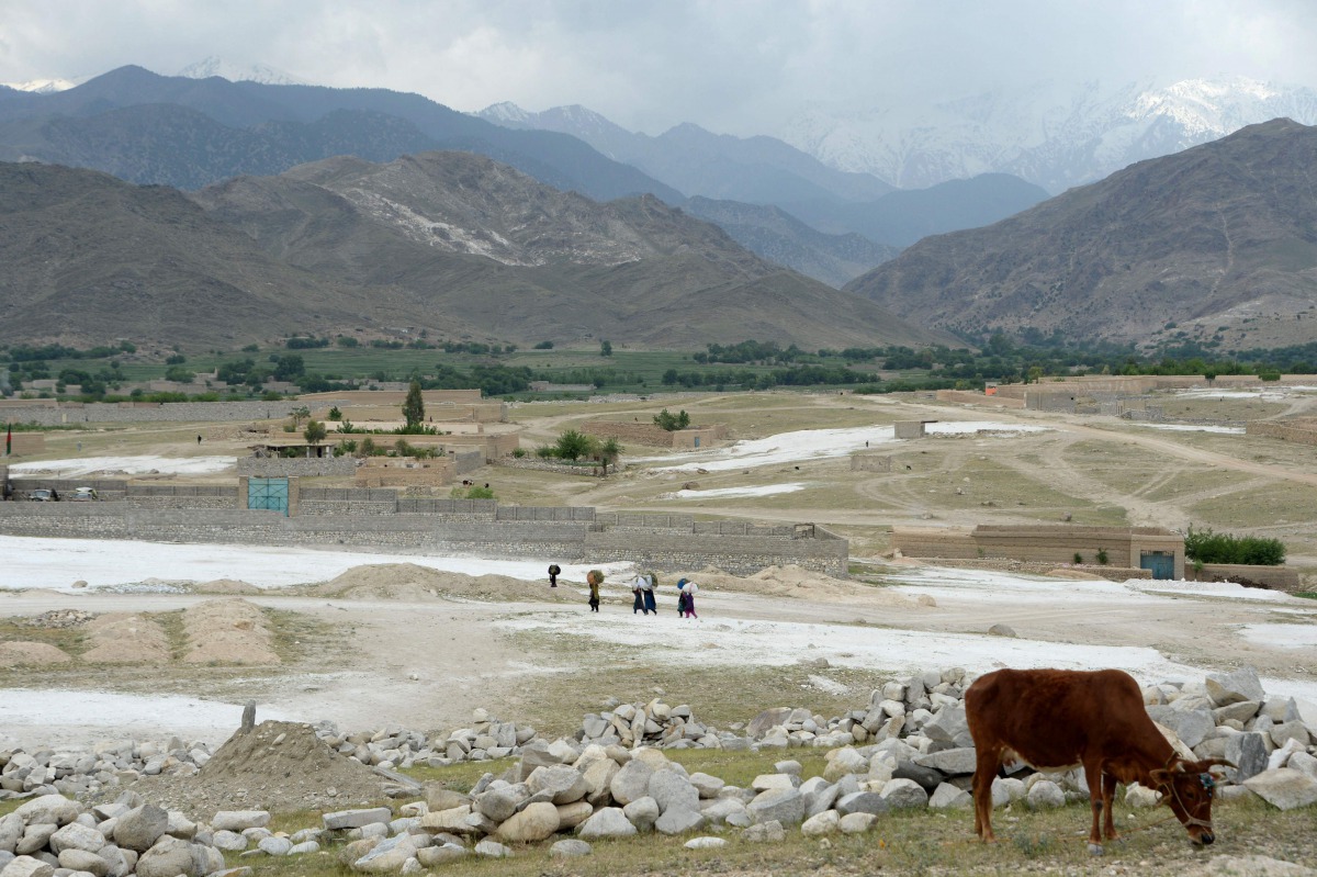 Afghan women walk through a village near the site of a bomb attack by US forces in the Achin district of Nangarhar province on April 22, 2017. Afghan authorities April 15 reported a jump in fatalities from the American military's largest non-nuclear bomb,