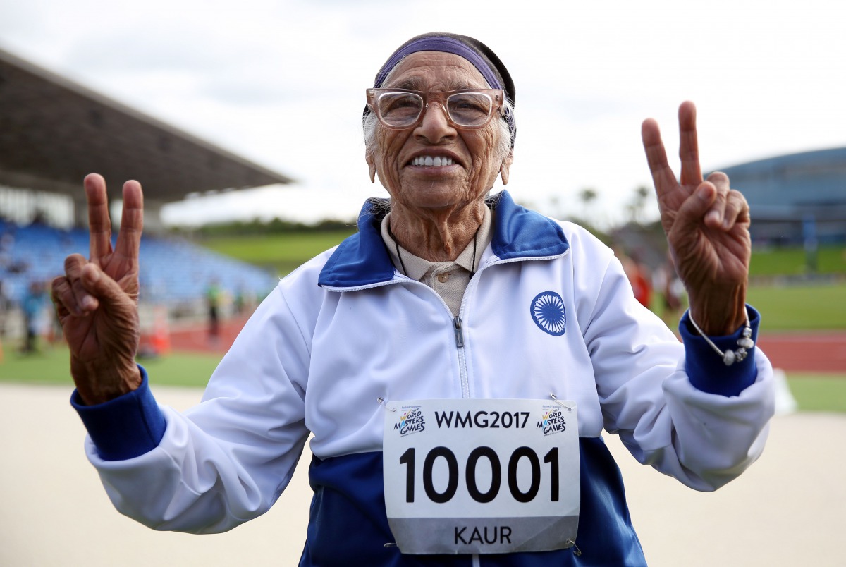 101-year-old Man Kaur from India celebrates after competing in the 100m sprint in the 100+ age category at the World Masters Games at Trusts Arena in Auckland on April 24, 2017. AFP / MICHAEL BRADLEY
