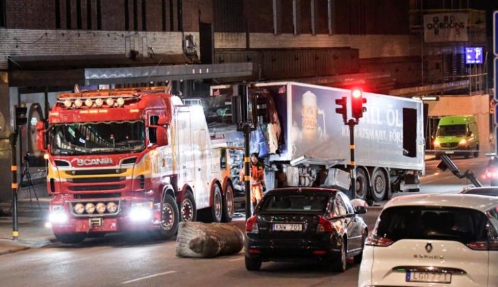 Tow trucks pull away the beer truck that crashed into the department store Ahlens after plowing down the Drottninggatan Street in central Stockholm, Sweden, April 8, 2017. Maja Suslin/TT News Agency/via Reuters.