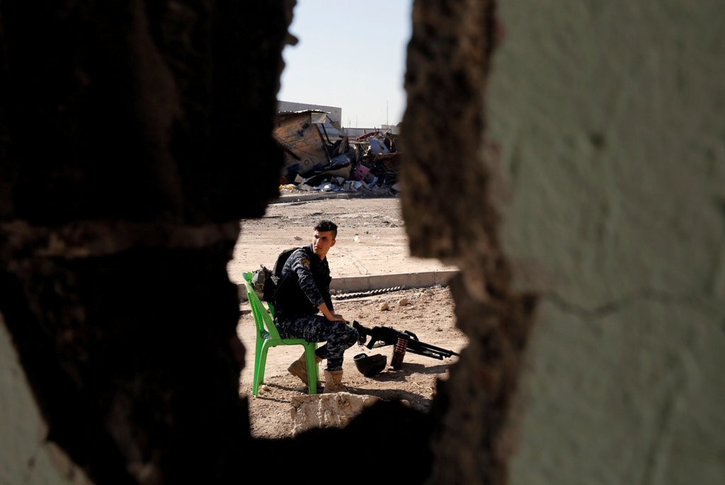 A member of the Iraqi Federal Police sits in guard during their fighting the Islamic State in western Mosul, Iraq, April 24, 2017. REUTERS/Muhammad Hamed 
