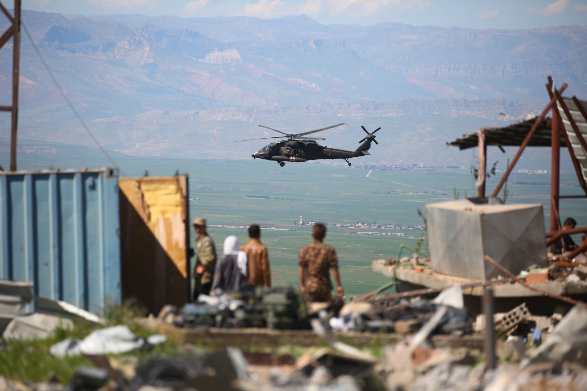 A medical helicopter, from the US-led coalition, flies over the site of Turkish airstrikes near northeastern Syrian Kurdish town of Derik, known as al-Malikiyah in Arabic, on April 25, 2017. AFP / Delil Souleiman