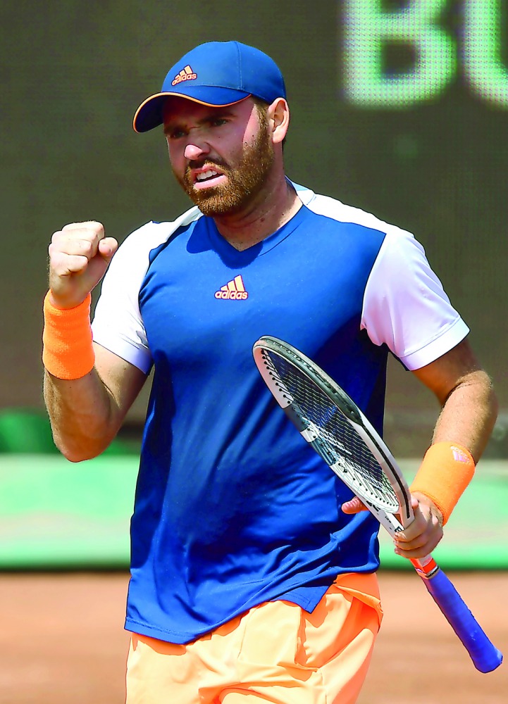 US Bjorn Fratangelo celebrates his victory over France's Gilles Simon during their tennis match at the Hungarian Open in Budapest, on April 25, 2017. Simon lost the match 6-4, 6-1. AFP / Attila Kisbenedek