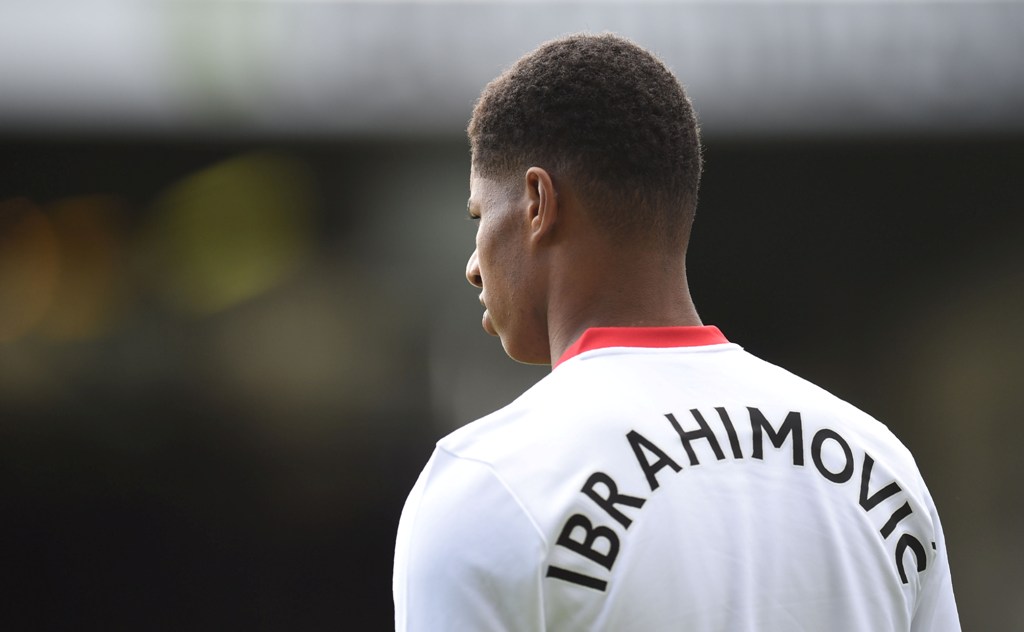 Manchester United's English striker Marcus Rashford warms up with a top spelling the name of Manchester United's Swedish striker Zlatan Ibrahimovic who was injured before the English Premier League football match between Burnley and Manchester United at T