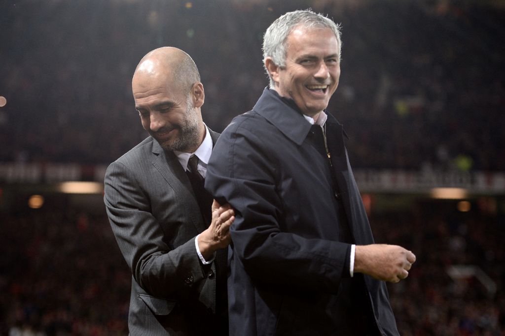 (FILES) This file photo taken on October 26, 2016 shows Manchester United's Portuguese manager Jose Mourinho (R) and Manchester City's Spanish manager Pep Guardiola sharing a joke ahead of the English League Cup fourth round match between Manchester Unite