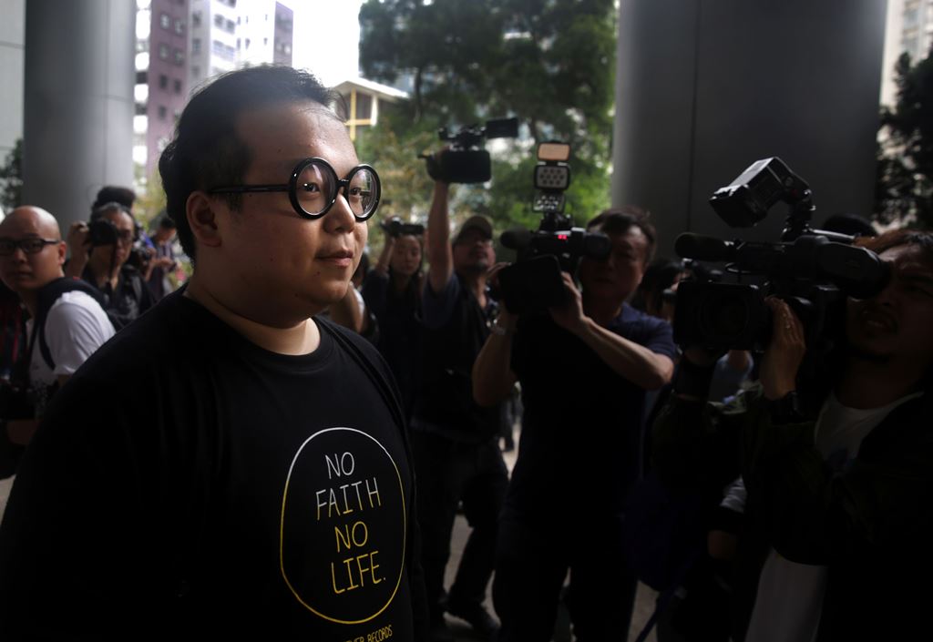 (FILES) This file photo taken on April 7, 2016 shows Scholarism activist Derek Lam (L) arriving at court in Hong Kong, where he had his charge of rioting during the Mong Kok protests withdrawn. AFP / Isaac Lawrence