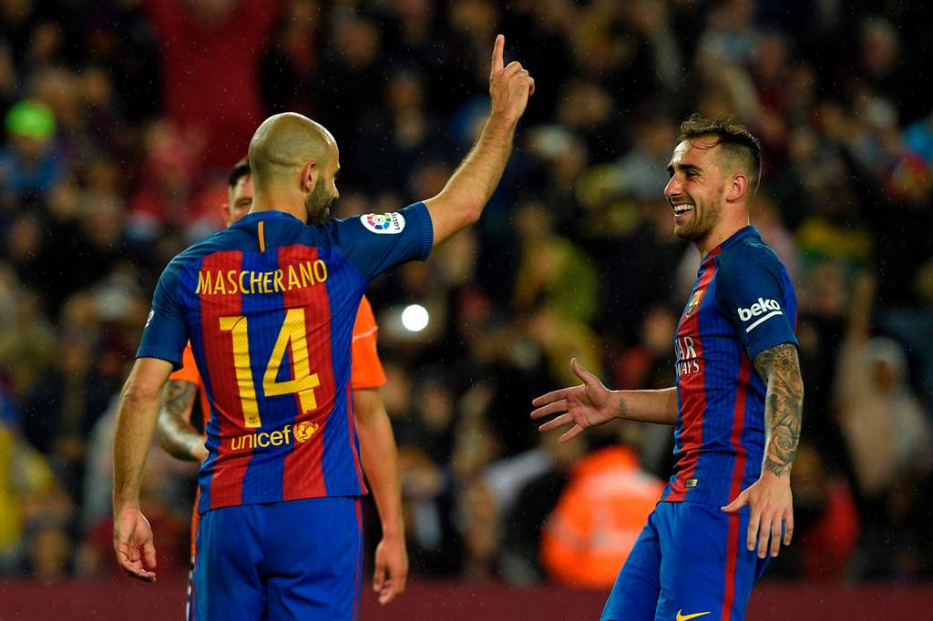 Barcelona's Argentinian defender Javier Mascherano (L) celebrates with Barcelona's forward Paco Alcacer (R) after scoring his first goal with FC Barcelona during the Spanish league football match FC Barcelona vs CA Osasuna at the Camp Nou stadium in Barce