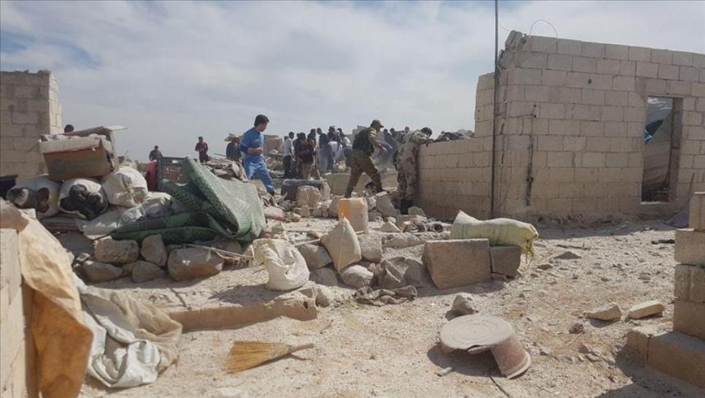 Syrians inspect debris after airstrikes in Idlib refugee camp on April 26, 2017. (Muhammed Karkas - Anadolu Agency).