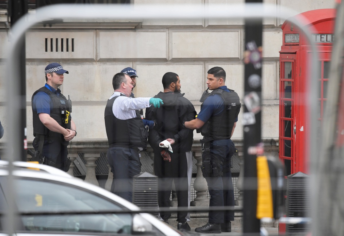 A man is held by police in Westminster after an arrest was made on Whitehall in central London, Britain, April 27, 2017. (REUTERS/Toby Melville)