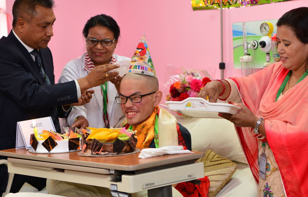 Taiwanese trekker Liang Sheng-yueh (C), who was rescued alive after being stranded in the Himalayas for 47 days, celebrates his 21st birthday in a hospital in Kathmandu on April 27, 2017.  AFP / Prakash Mathema