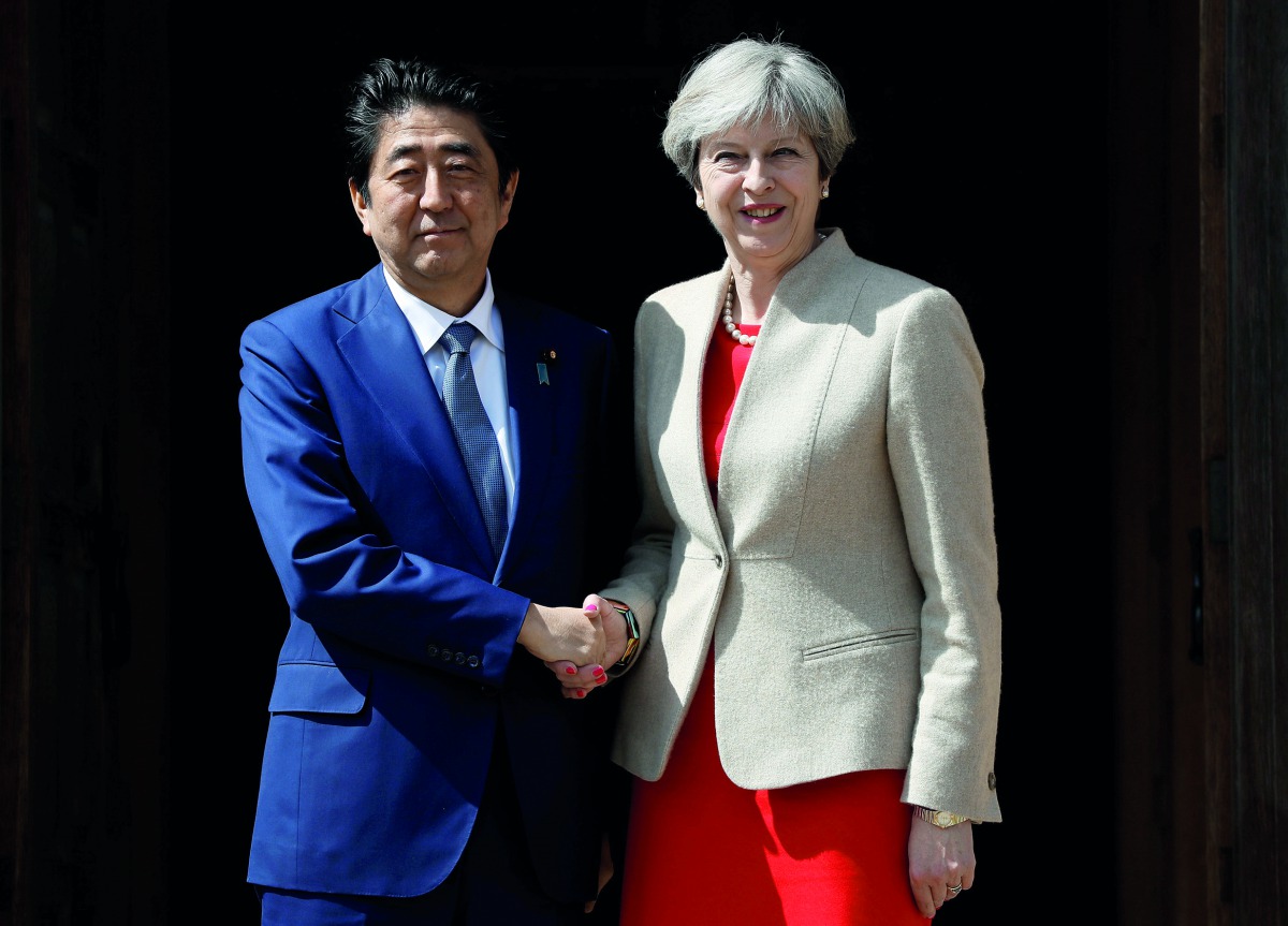 Britain's Prime Minister Theresa May (right) greets Japan's Prime Minister Shinzo Abe during a visit to Chequers, near Wendover, Britain