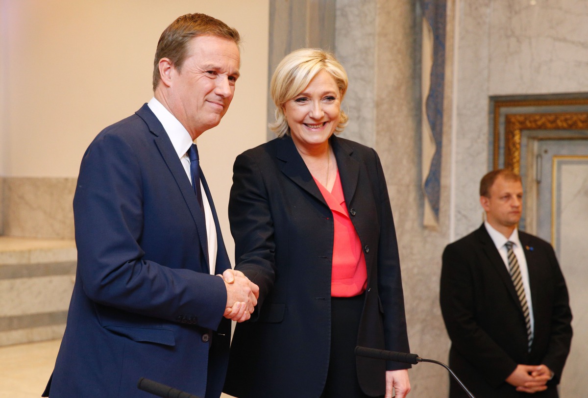 French presidential election candidate for the far-right Front National (FN) party Marine Le Pen (R), flanked by Former French presidential election candidate for the right-wing Debout la France (DLF) party Nicolas Dupont-Aignan (L), gestures as she speak