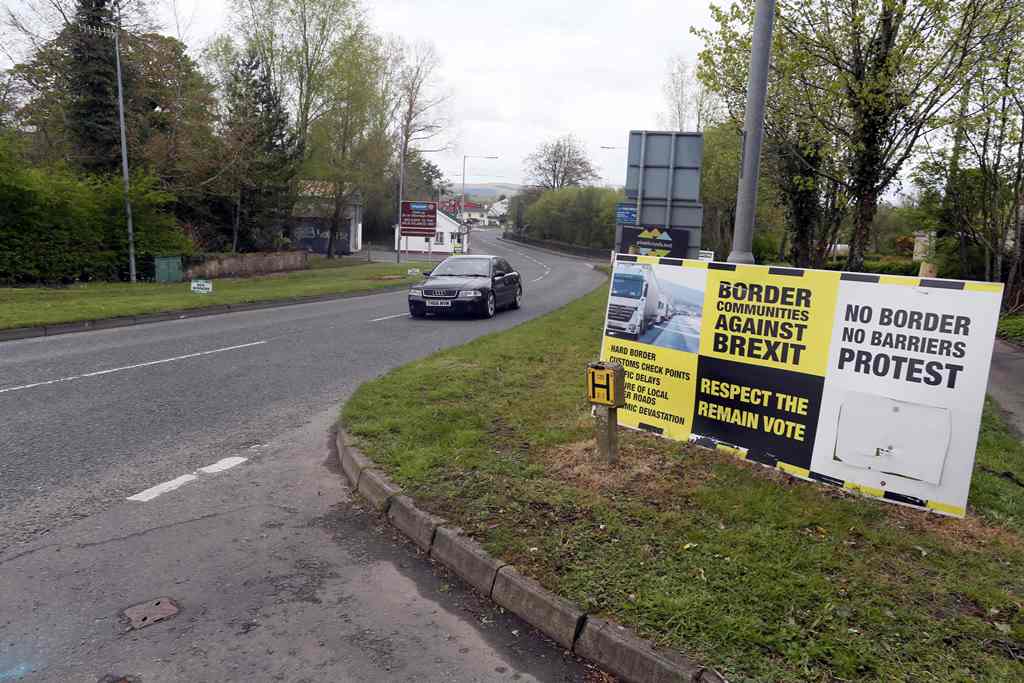In this photograph taken on April 26, 2017, Brexit posters are pictured at the border crossing at Muff in Co Donegal near Lough Foyle, on the border with Northern Ireland and Donegal in the Republic of Ireland. AFP / PAUL FAITH