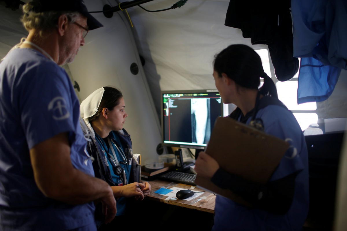 Foreign volunteers work at the emergency field hospital which is run by the US Christian charity Samaritans Purse eastern Mosul Iraq March 22 2017 REUTERS Suhaib Salem