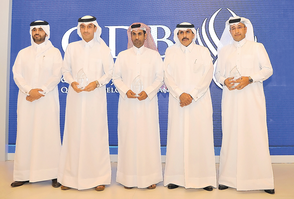 H E Sheikh Abdullah bin Saud Al Thani (second right) and Abdulaziz bin Nasser Al Khalifa (left) with top officials of the winning banks during Al Dhameen Program Best Partner Bank award ceremony yesterday. Pic: Baher Amin/ The Peninsula