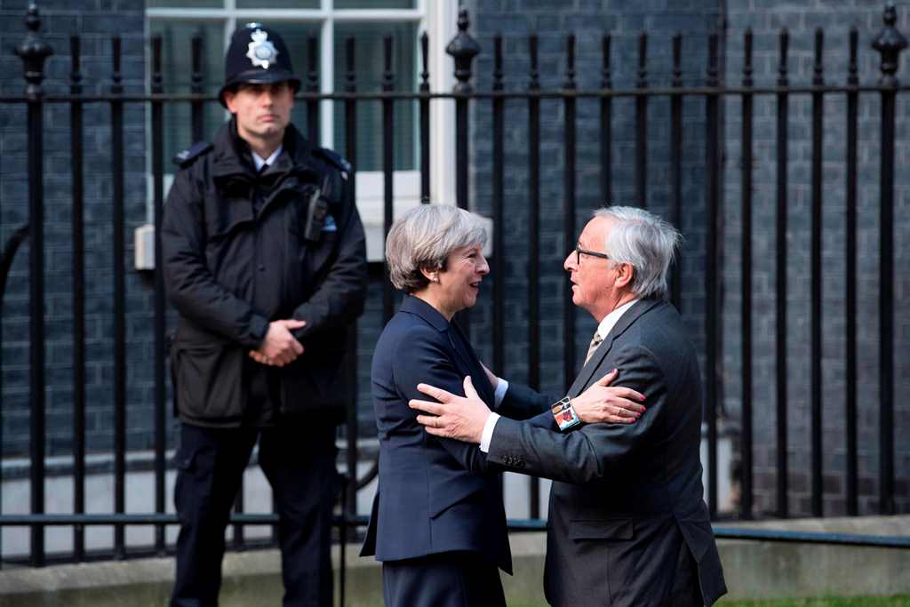 (FILES) This file photo taken on April 26, 2017 shows European Commission President, Jean-Claude Juncker (R) being greeted by British Prime Minister Theresa May outside 10 Downing Street in London on April 26, 2017. AFP / Justin TALLIS