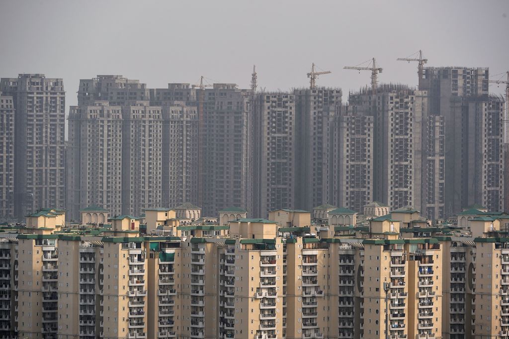 This photograph taken on April 27, 2017, shows incomplete residential apartments in Greater Noida, some 25 kilometres (16 mi) south-east of New Delhi. AFP / CHANDAN KHANNA 