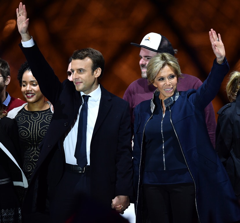 PARIS, FRANCE - MAY 07 : French presidential election candidate for the 'En Marche!' (Onwards!) political movement, Emmanuel Macron (L) greets with his wife Brigitte Trogneux (R) after winning the 2017 French election at the Esplanade du Louvre in Paris, 