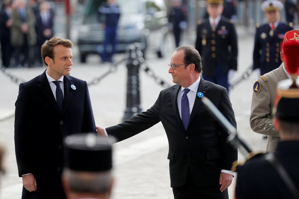Outgoing French President Francois Hollande (R) and President-elect Emmanuel Macron attend a ceremony to mark the end of World War II at the Tomb of the Unknown Soldier at the Arc de Triomphe in Paris, France, May 8, 2017. REUTERS/Philippe Wojazer