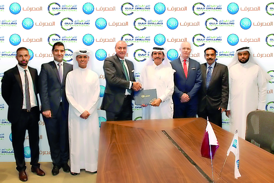 Bassel Gamal, Group Chief Executive Officer of QIB;  and Mubarak A. Al Hajri, Chief Executive Officer and MD of GDI shaking hands after the signing ceremony.