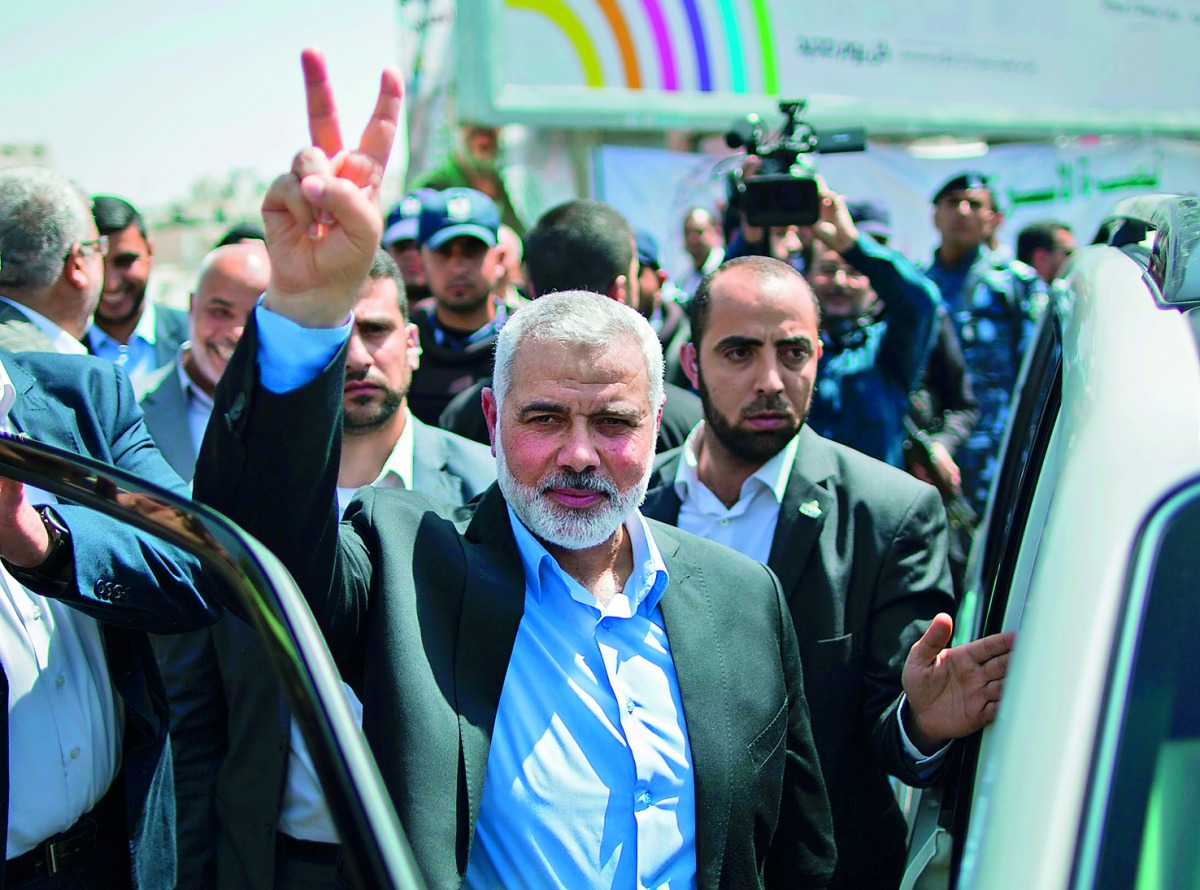Newly elected Hamas chief Ismail Haniyah flashes the V-sign after attending a rally in support of Palestinian hunger-striking prisoners held in Israeli jails, in Gaza City, yesterday. 