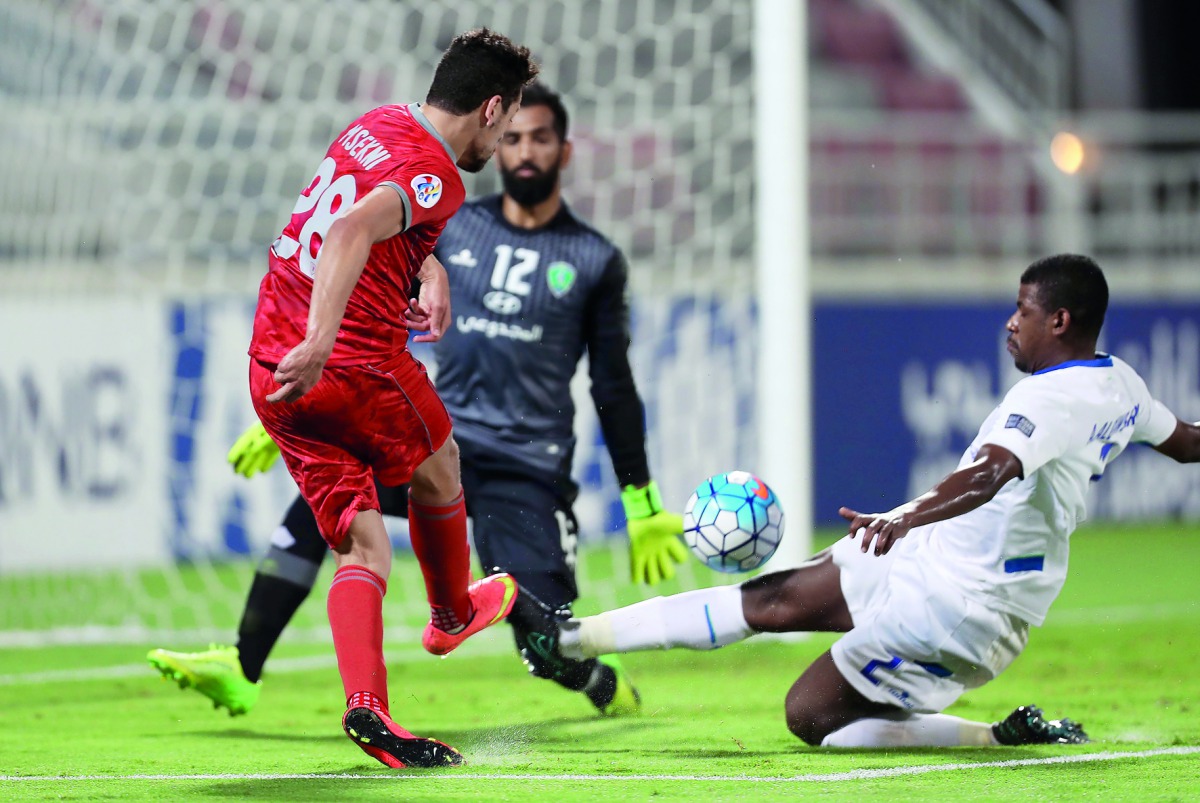 Lekhwiya's  Youssef Msakni (left) scores their second goal against Saudi Arabia's Al Fateh during the AFC Champions League football match played at the Abdullah bin Khalifa stadium in Doha yesterday. Lekhwiya registered an emphatic 4-1 win to confirm them