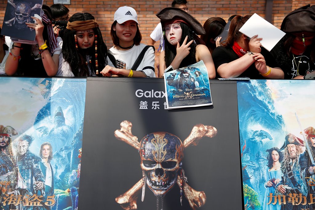 Fans pose for pictures ahead of the red carpet event for the global premiere of the film 