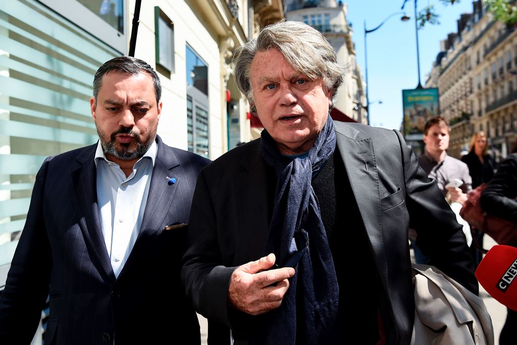 Far-right Front National (FN) party member of parliament Gilbert Collard (R) arrives at 