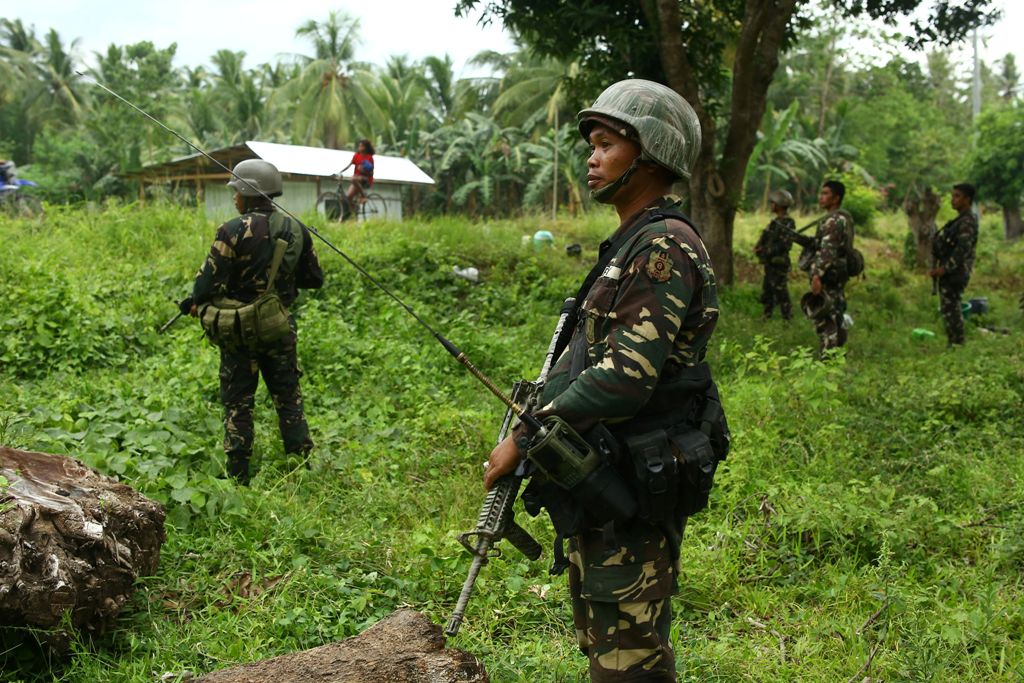 This photo taken on May 10, 2017 shows Philippine soldiers patrolling along a village near a highway in Maguindanao province, in southern island of Mindanao, after almost a week of attacks on members of the Bangsamoro Islamic Freedom Fighters (BIFF).   AF