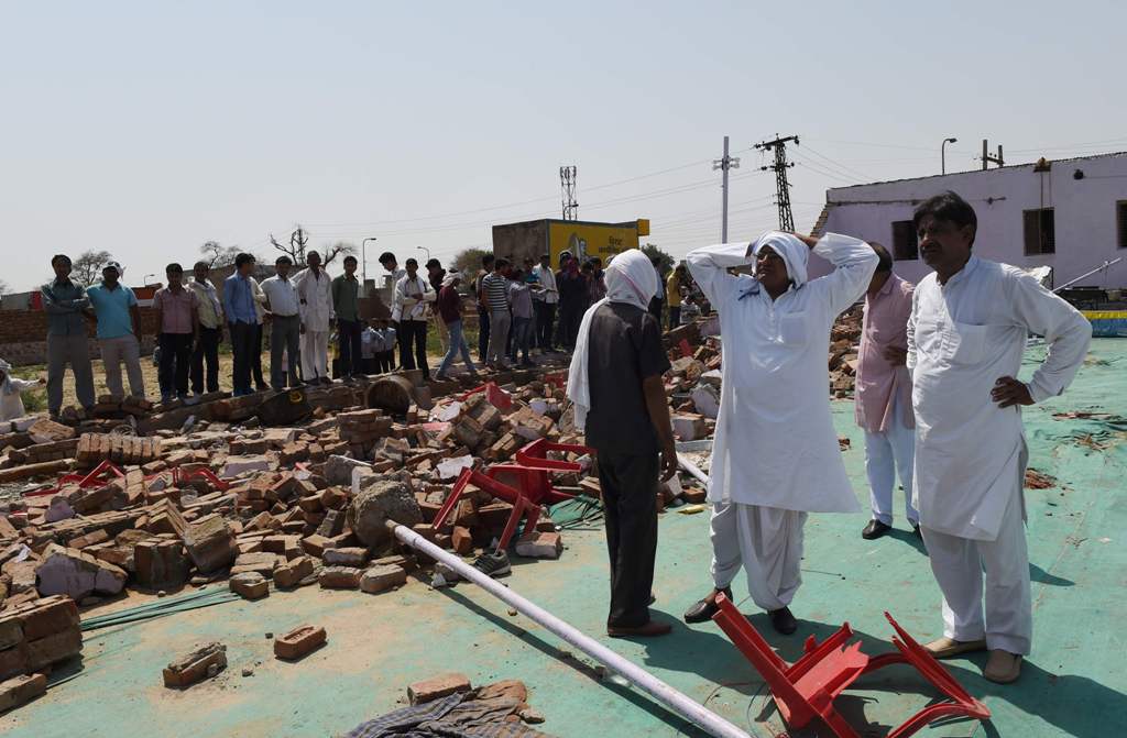 A wall crashed down on an Indian wedding party during a storm killing at least 24 people including four children, police said, with one rescuer describing the scene as 